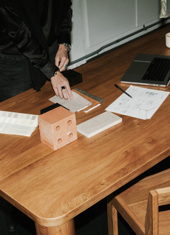 Maker marking out a timber joint on a workbench